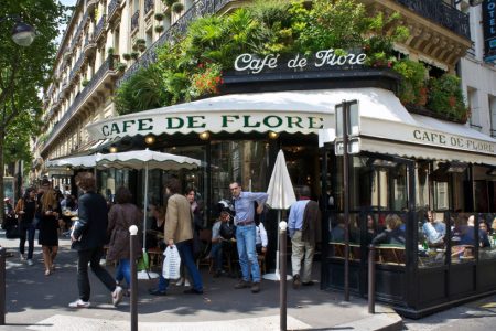Paris Cafe Paris, France - July 14, 2011 - Diners enjoy the sun at the famous Cafe de Flore in Paris. The cafe lifestyle draws millions of tourists to Paris each year.